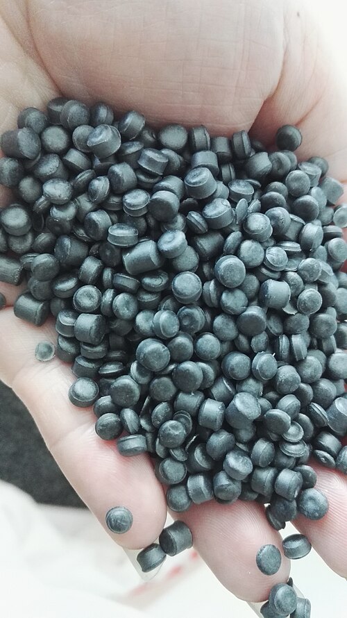 Plastic resin pellets, the raw material verified by FTIR at incoming inspection.