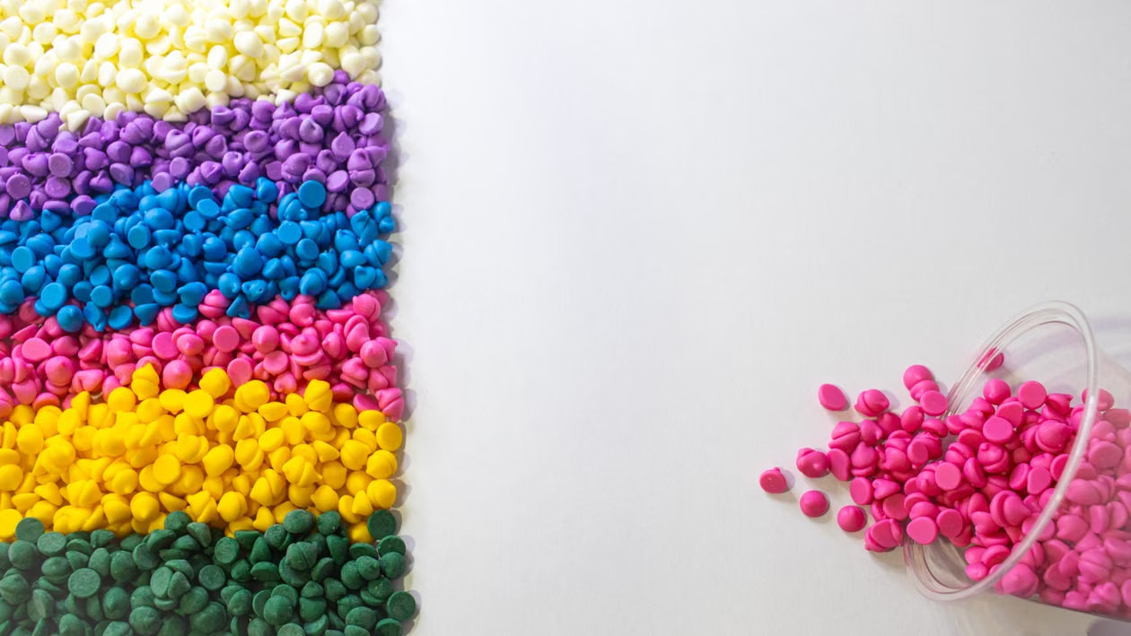 Plastic resin pellets, the form in which raw material usually arrives and is checked before processing.